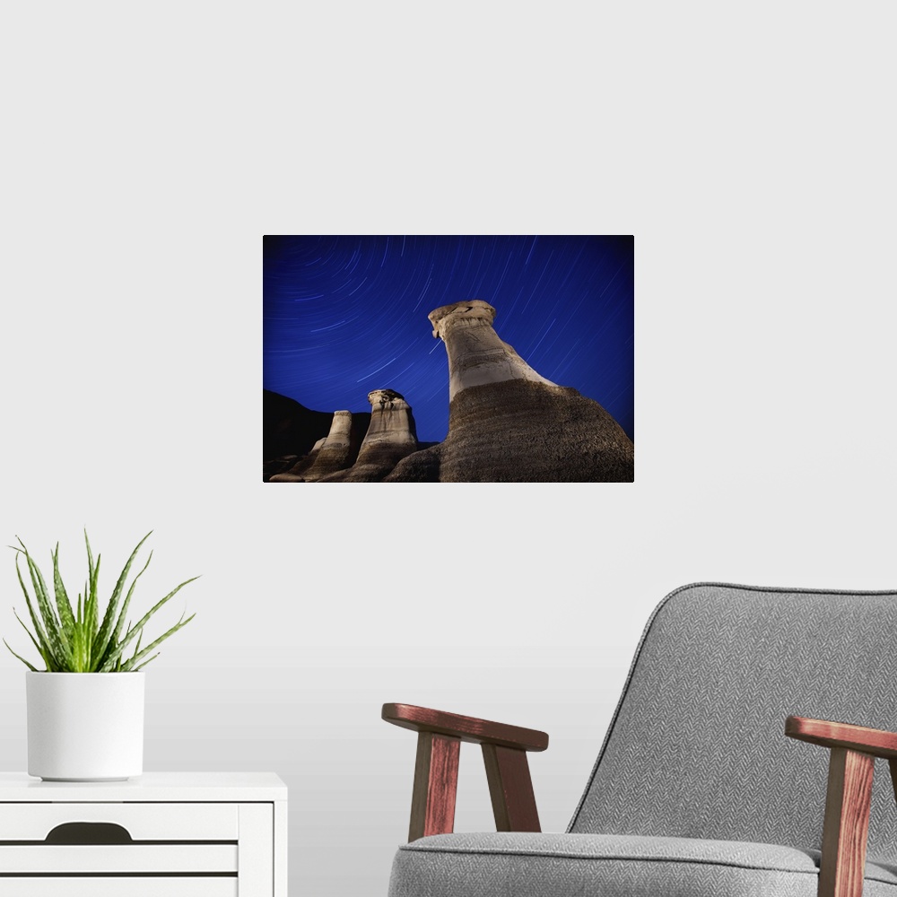 A modern room featuring Hoodoos And Star Trails In The Sky; Drumheller, Alberta, Canada
