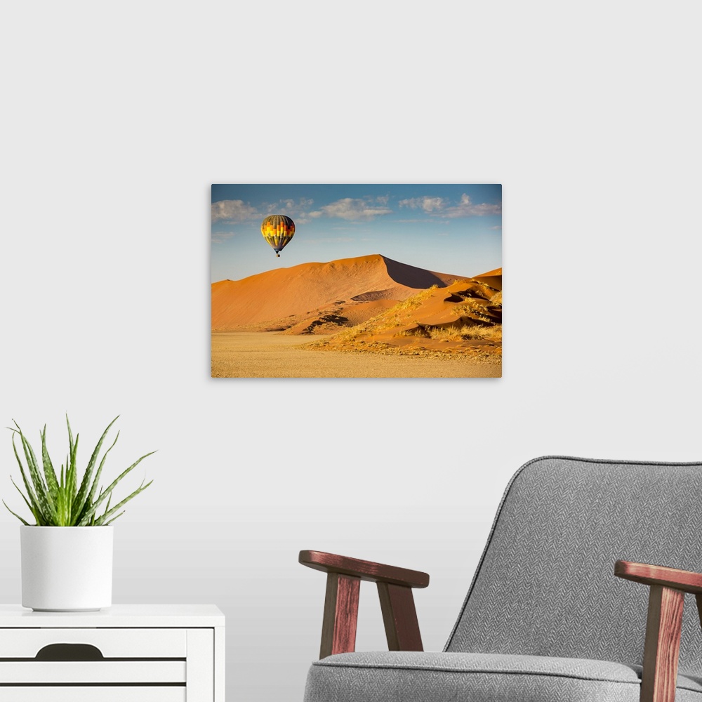 A modern room featuring Hot air balloon ride over the red sand dunes of Sossusvlei in Namibia; Sossusvlei, Hardap Region,...