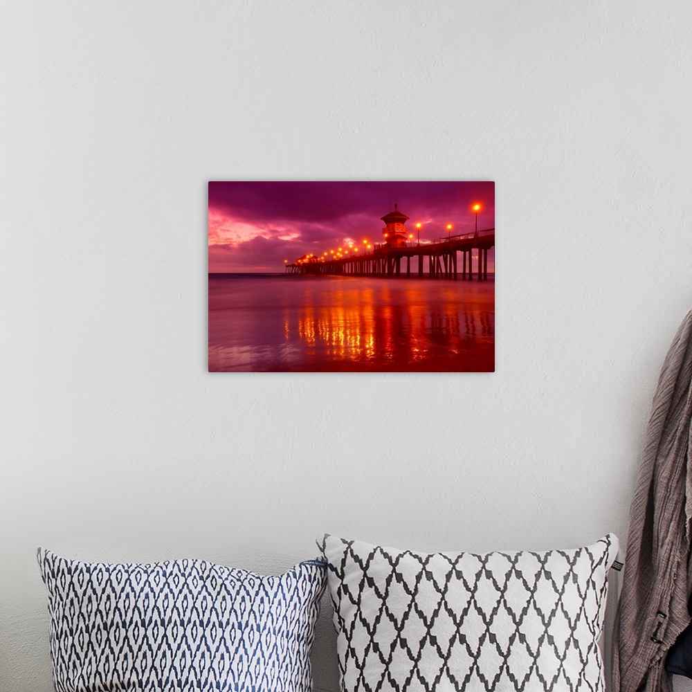 A bohemian room featuring Big horizontal photograph of a lit pier reflecting in the water near Huntington beach at dusk, be...
