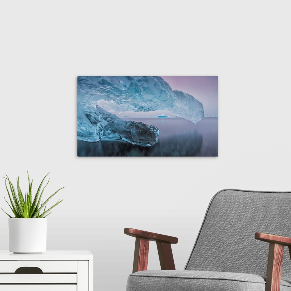 A modern room featuring Iceberg on the beach along the south coast of Iceland with a river flowing by it leading towards ...