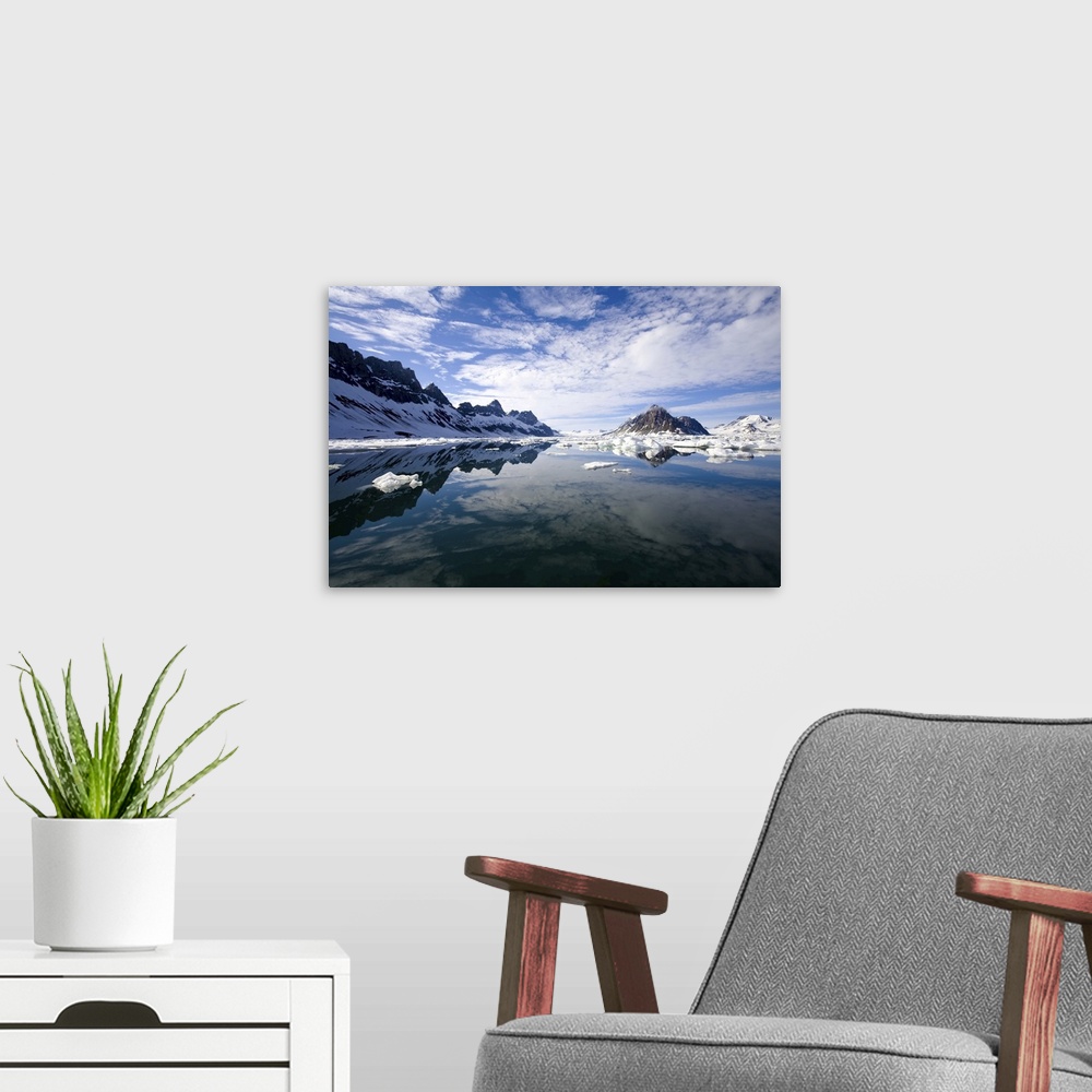 A modern room featuring Jagged coastal peaks casting reflections in cold Arctic waters.