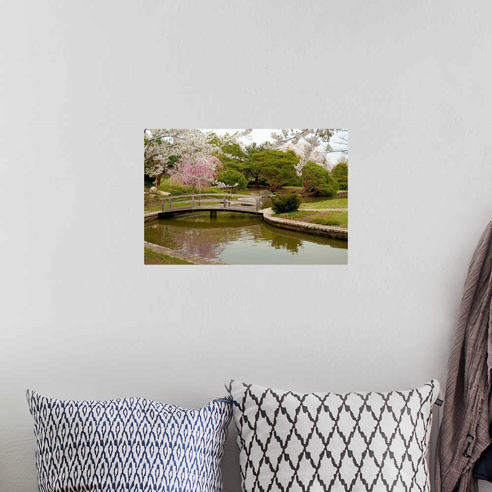 A bohemian room featuring Large canvas photo art of a bridge crossing a river with flowering Japanese trees sprinkled aroun...