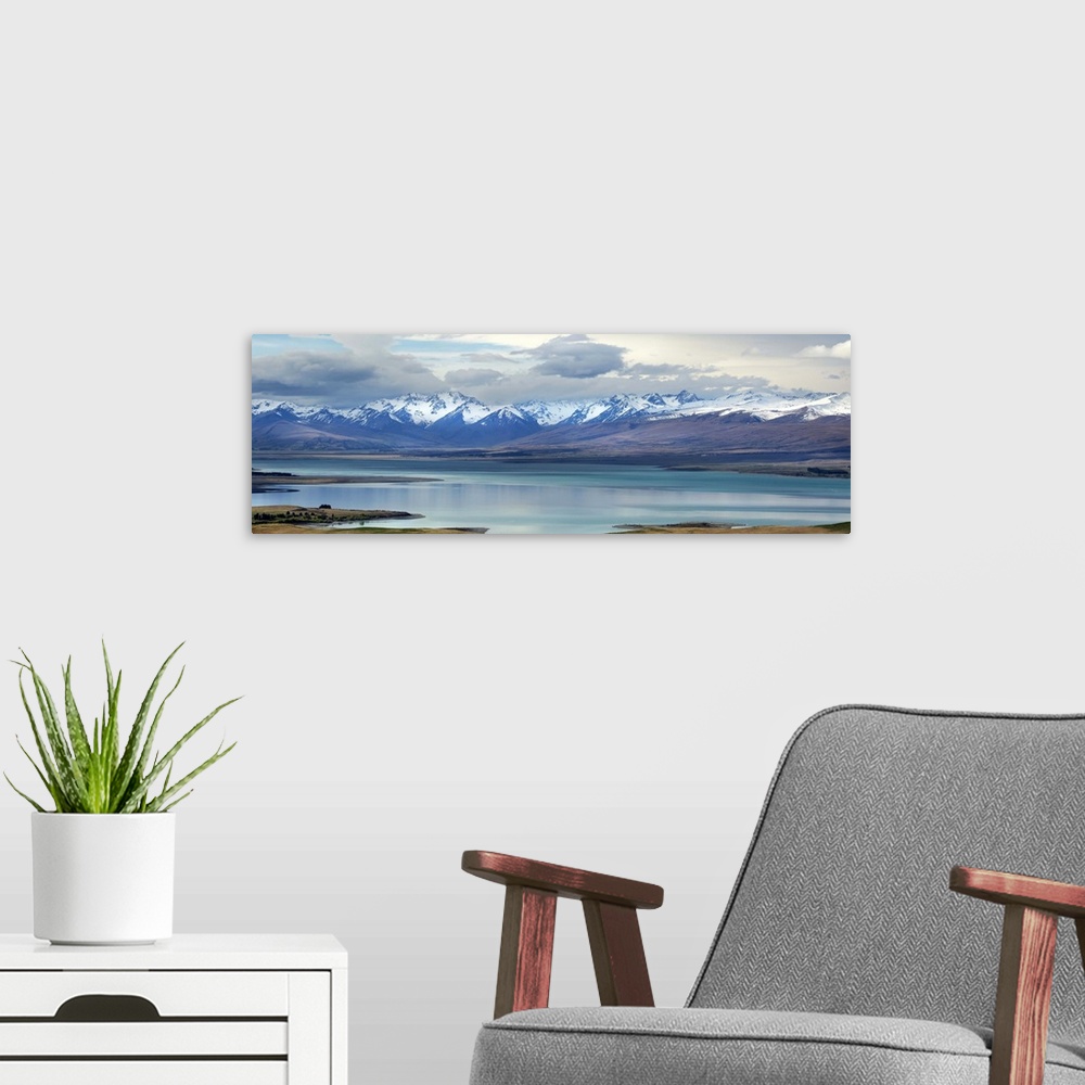 A modern room featuring Lake Tekapo, with snow covered mountains. Tekapo, New Zealand.