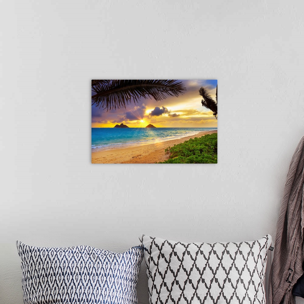 A bohemian room featuring Sunrise viewed from Lanikai Beach with a view of the Mokulua Islands off the coast; Oahu, Hawaii,...