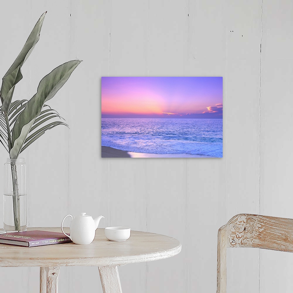 A farmhouse room featuring A breathtaking photograph of a sunset over the vast ocean giving the overall picture a soft color...