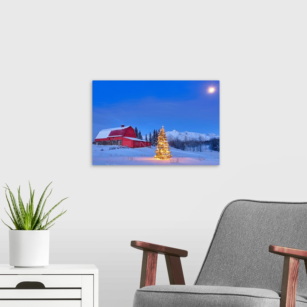 A modern room featuring Lit christmas tree in a snow covered field standing in front of a red barn