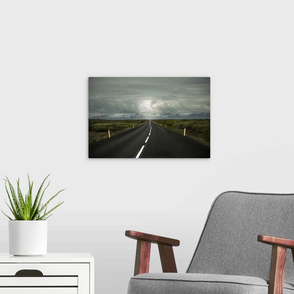A modern room featuring Long straight empty road leading to mountains in Iceland.