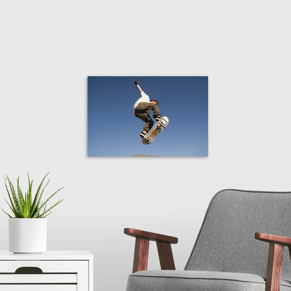 A modern room featuring Low Angle View Of Young Male Skateboarder