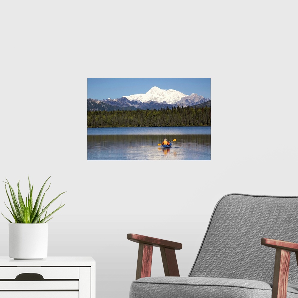 A modern room featuring A man paddles a Klepper kayak on Byers Lake, Denali State Park, Alaska. Mt. McKinley is in the ba...
