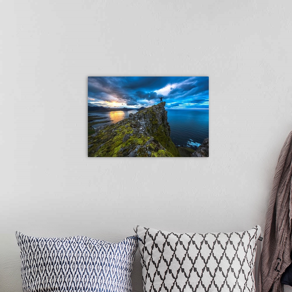 A bohemian room featuring Man standing on top of a sea cliff at sunset along Iceland's Strandir Coast in the West Fjord reg...
