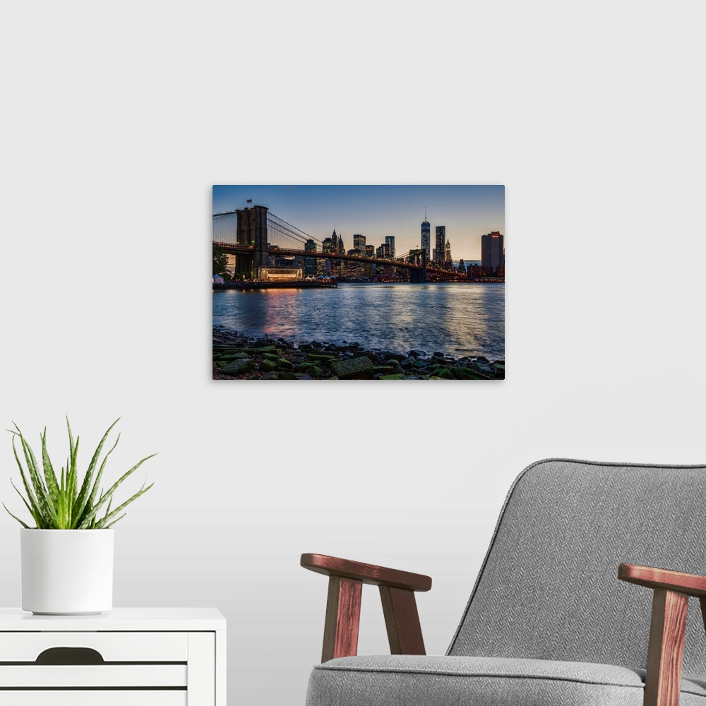 A modern room featuring Manhattan skyline at twilight with Brooklyn Bridge, Brooklyn Bridge Park, Brooklyn, New York City...