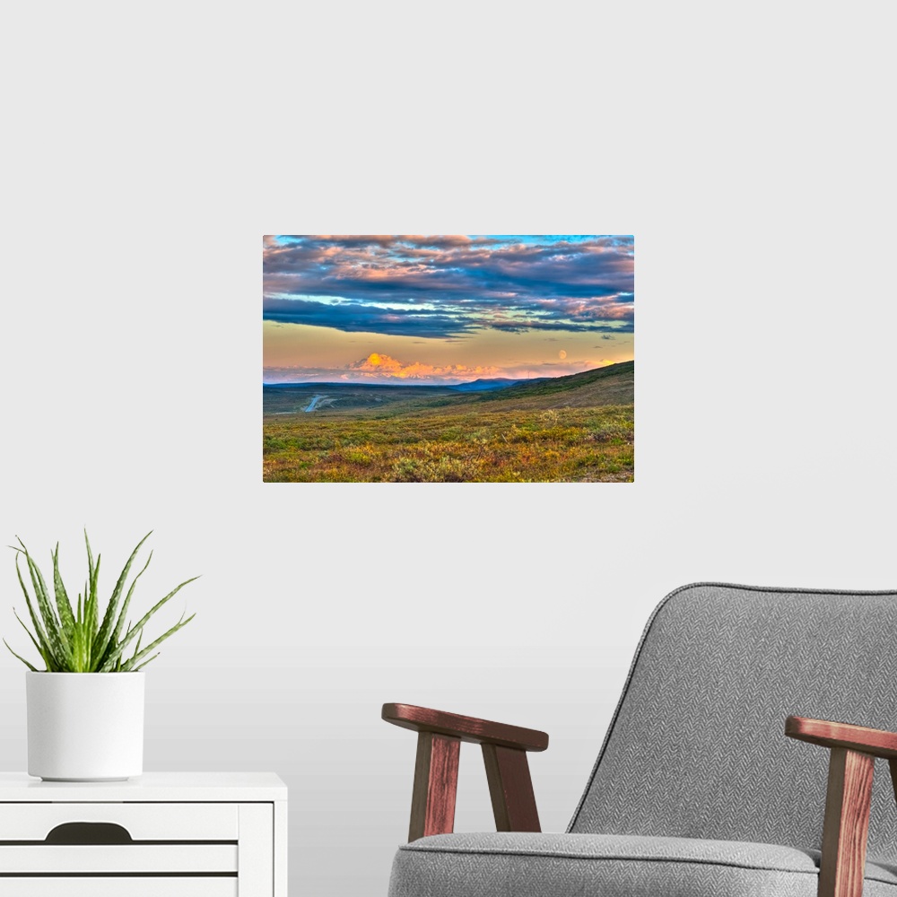 A modern room featuring Moon rising and Mount Drum at sunset along the Denali Highway