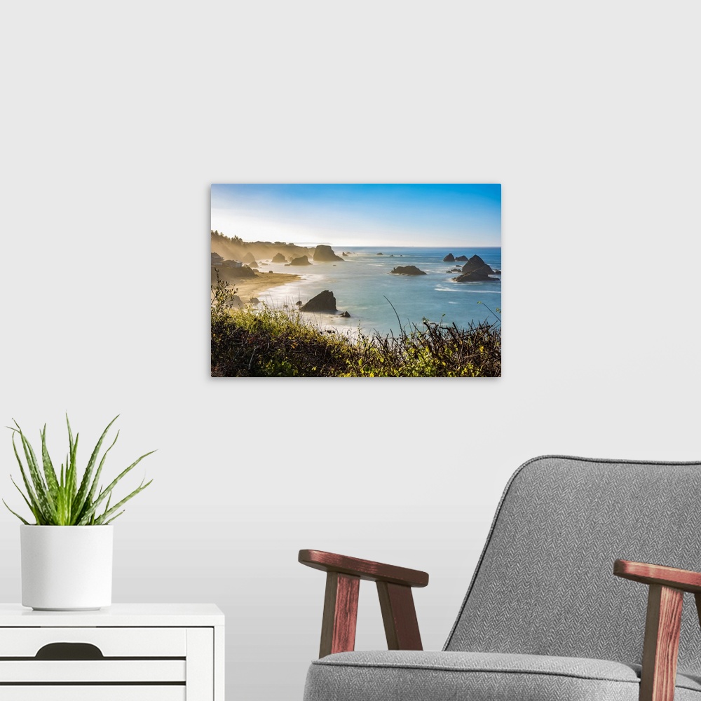 A modern room featuring Morning mist rising from Harris Beach, near Brookings, Oregon. The rock formations add to the vie...