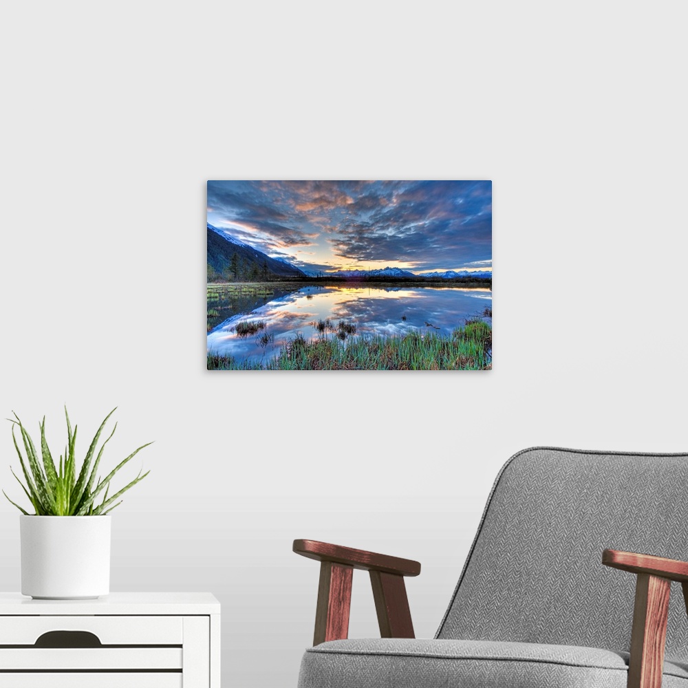 A modern room featuring Morning sky reflecting on a pond near the Copper River Highway outside of Cordova.  Four image HD...