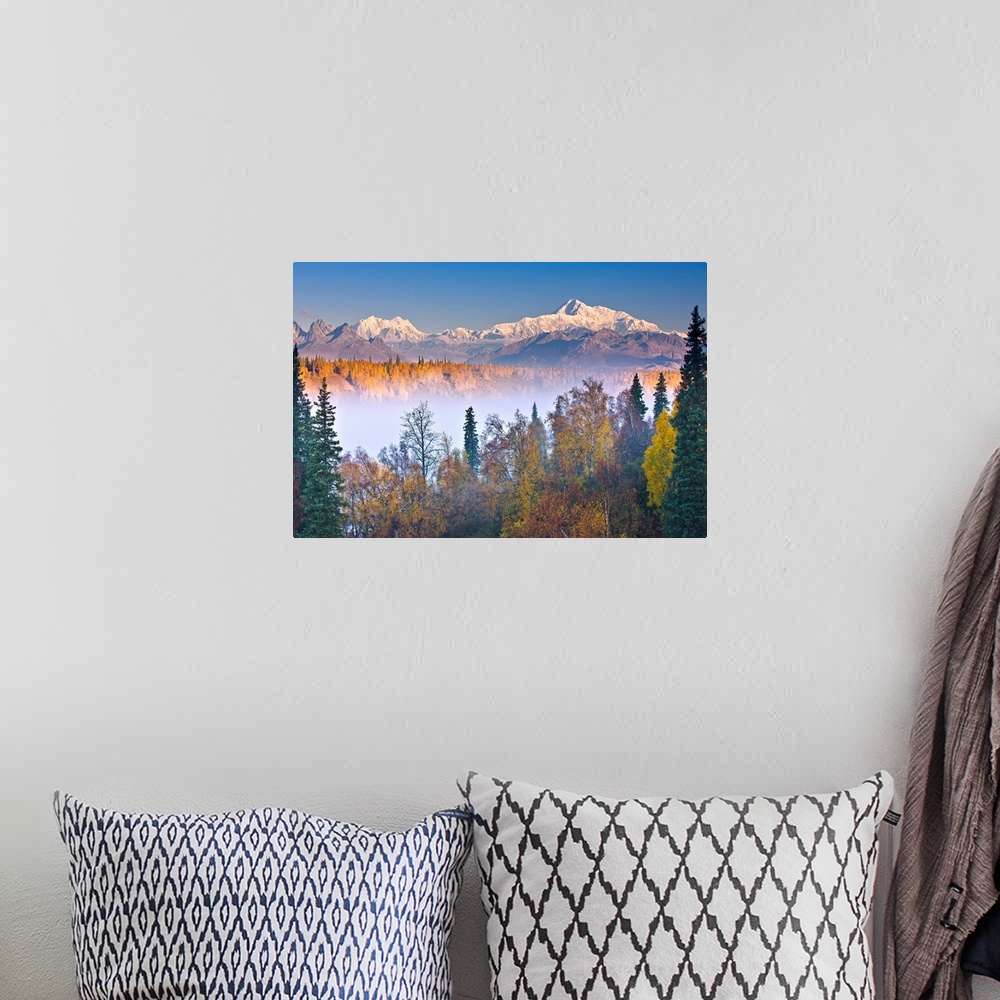A bohemian room featuring The early morning sun lights up Mount McKinley, and the Alaska range as fog covers the Chulitna R...