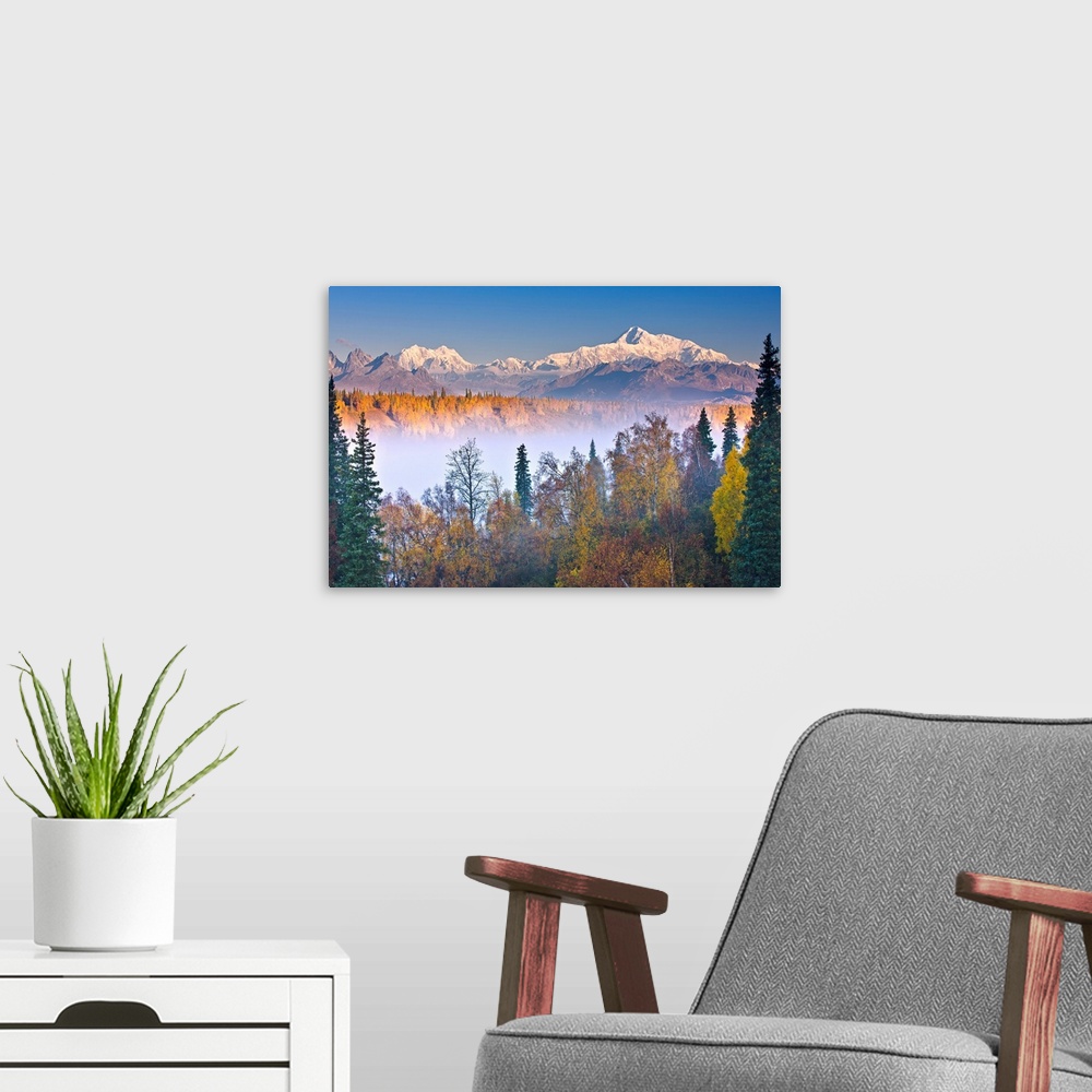 A modern room featuring The early morning sun lights up Mount McKinley, and the Alaska range as fog covers the Chulitna R...