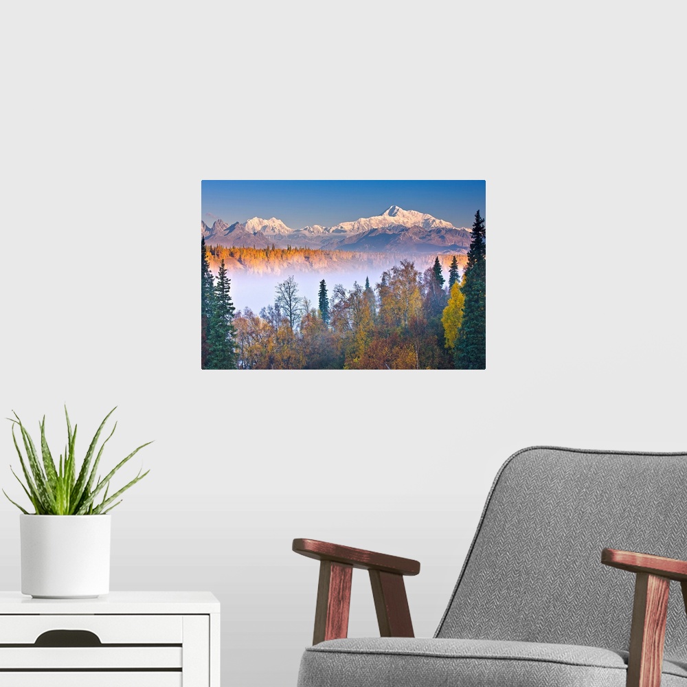 A modern room featuring The early morning sun lights up Mount McKinley, and the Alaska range as fog covers the Chulitna R...