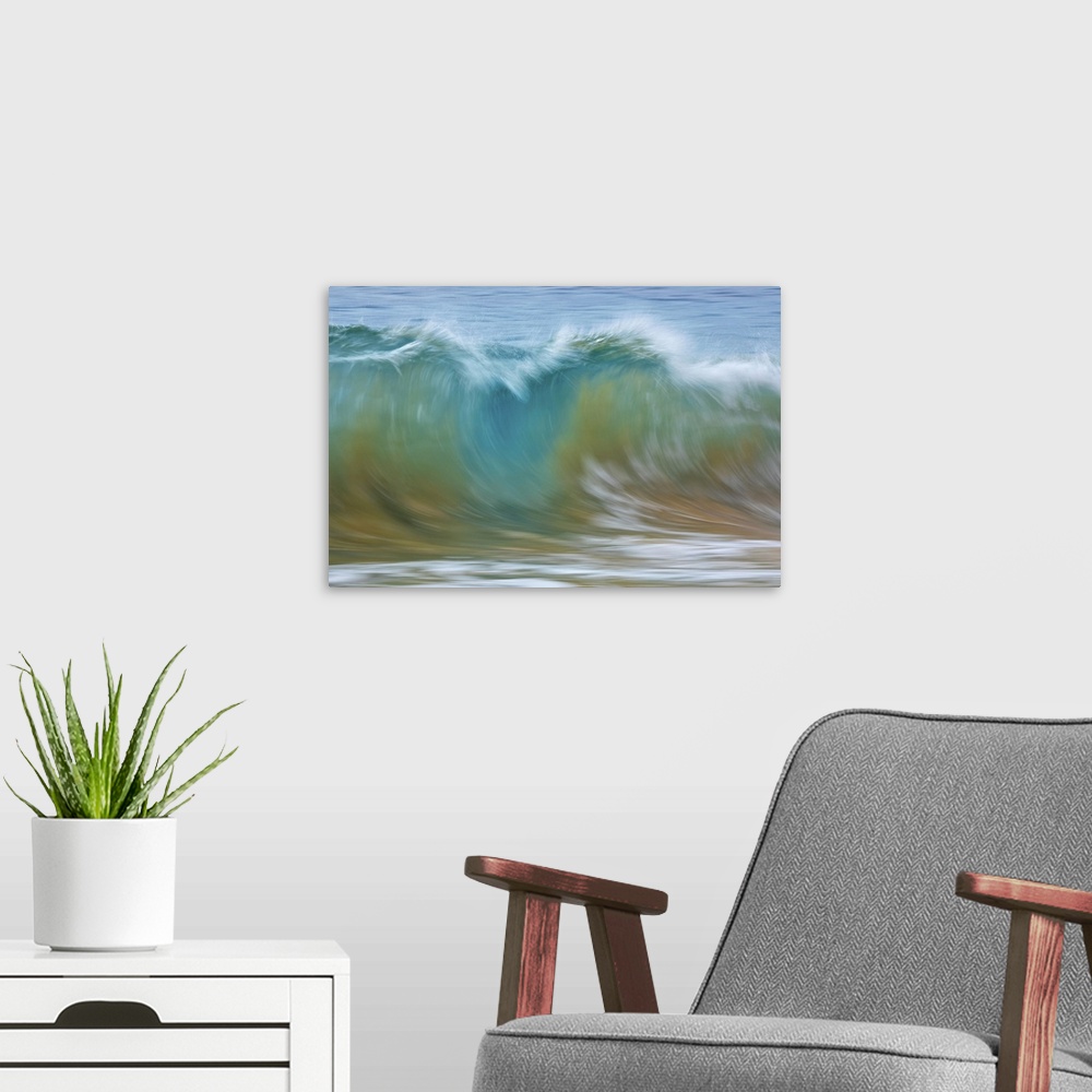 A modern room featuring Motion blur of blue rolling waves carrying golden sand at the shore; Kihei, Maui, Hawaii, United ...
