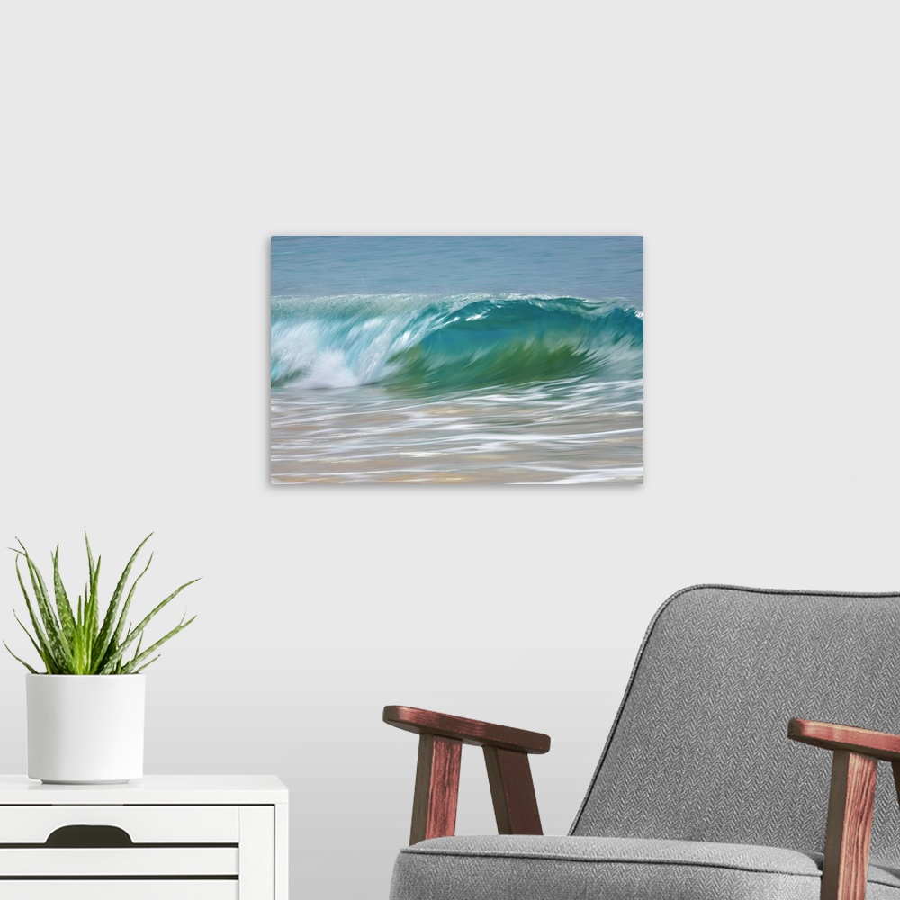 A modern room featuring Motion blur of blue rolling waves rolling into the golden sand at the shore; Kihei, Maui, Hawaii,...