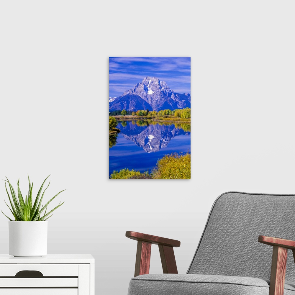 A modern room featuring Mount Moran of the Grand Tetons reflected in Snake River in Grand Teton National Park in autumn W...