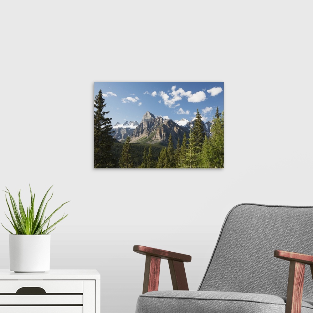 A modern room featuring Mountain Vista With Cliff Face And Blue Sky And Clouds; Alberta, Canada