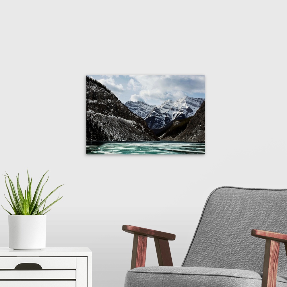 A modern room featuring Mountains and frozen lake in winter, Bow Valley Wildland. Alberta, Canada.