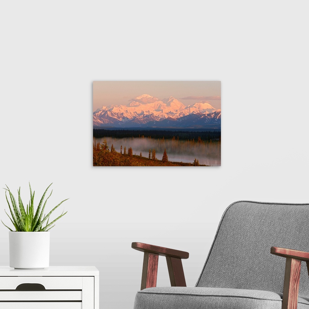 A modern room featuring Mt. Mckinley reflected in small lake at sunrise in Broad Pass, Denali National Park