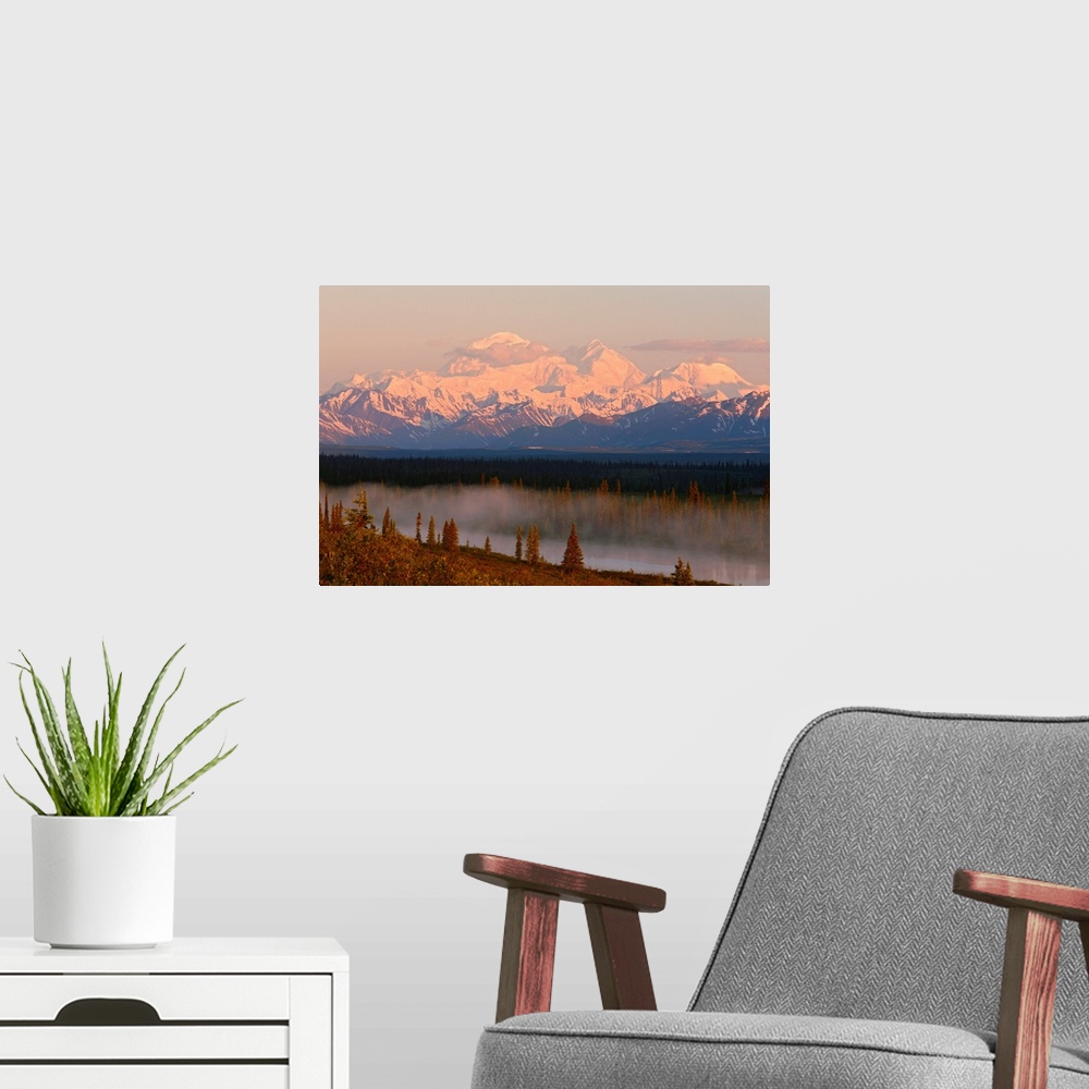 A modern room featuring Mt. Mckinley reflected in small lake at sunrise in Broad Pass, Denali National Park