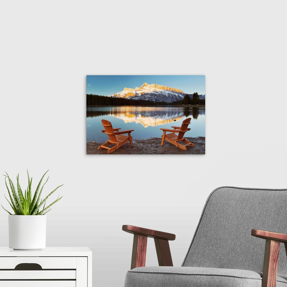 A modern room featuring Muskoka Chairs In Front Of Mt Rundle And Two Jack Lake, Alberta, Canada