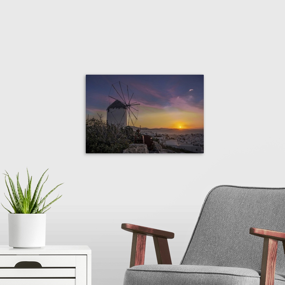 A modern room featuring Mykonos windmill at sunset.