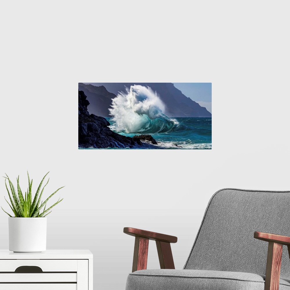 A modern room featuring Large ocean wave crashes into rock along the Na Pali Coast; Kauai, Hawaii, United States of America