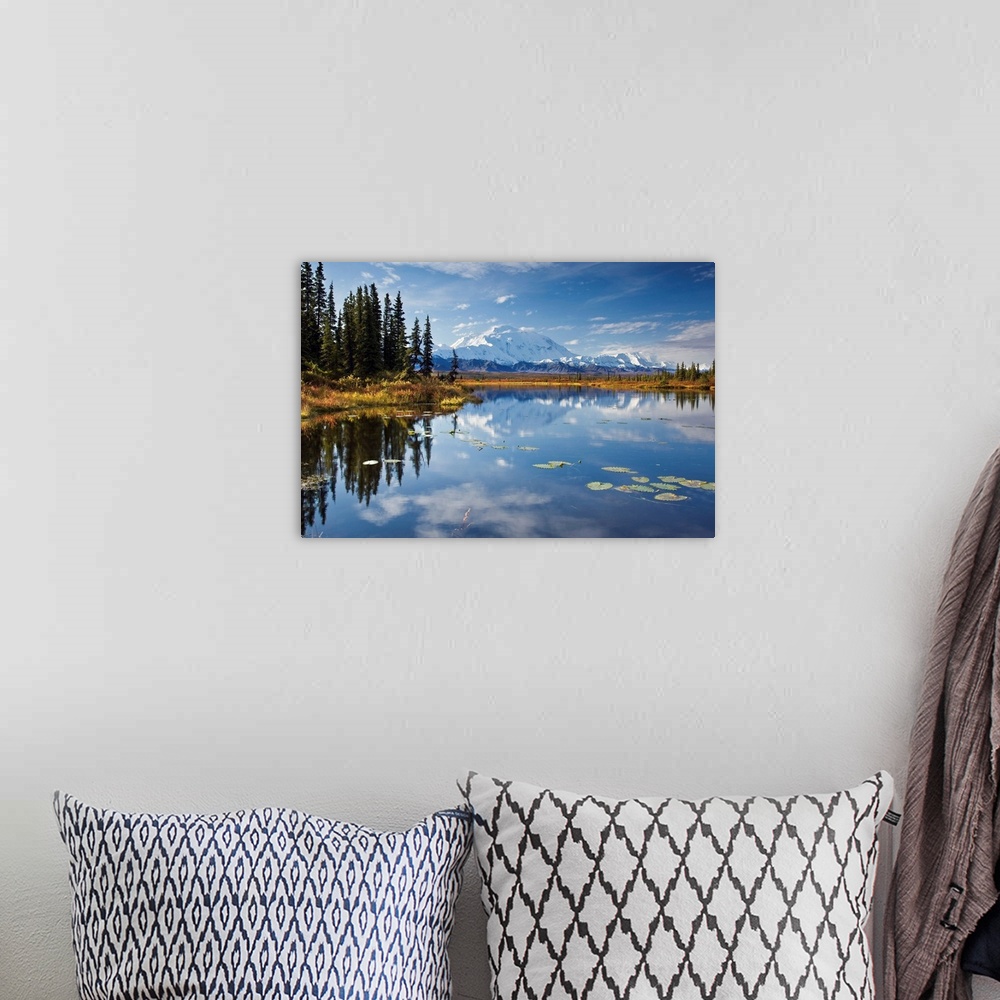 A bohemian room featuring This is a landscape photograph of the Alaskan sky, trees, and mountains mirrored in still waters.