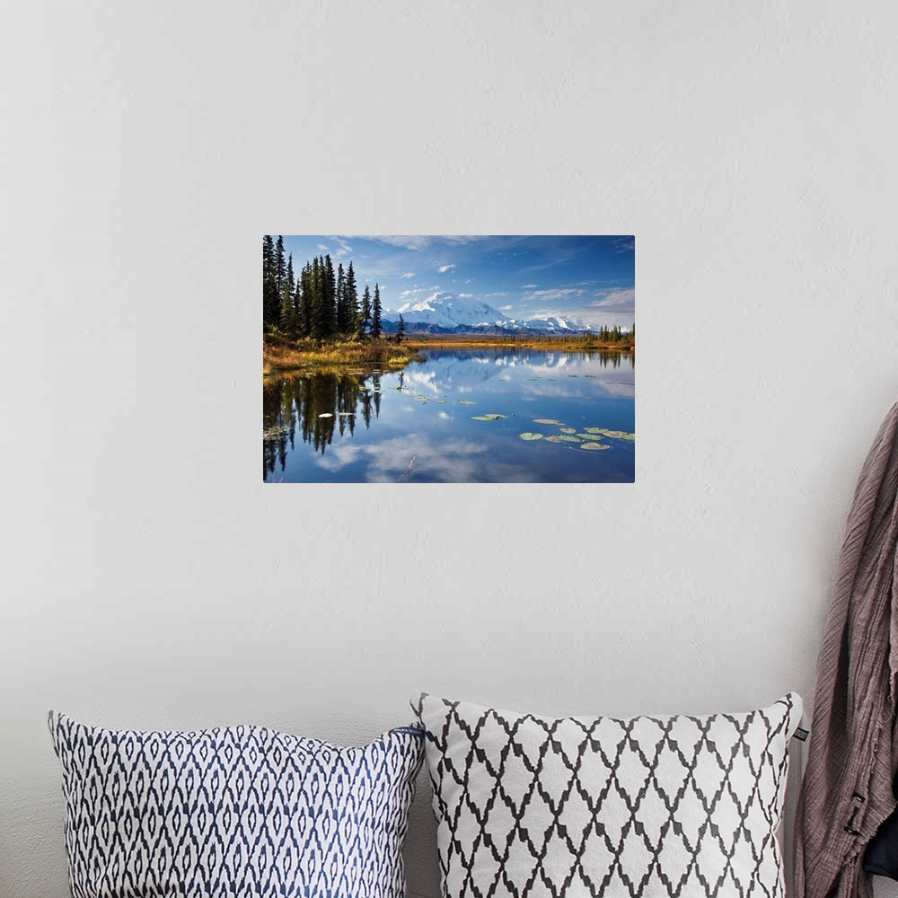 A bohemian room featuring This is a landscape photograph of the Alaskan sky, trees, and mountains mirrored in still waters.