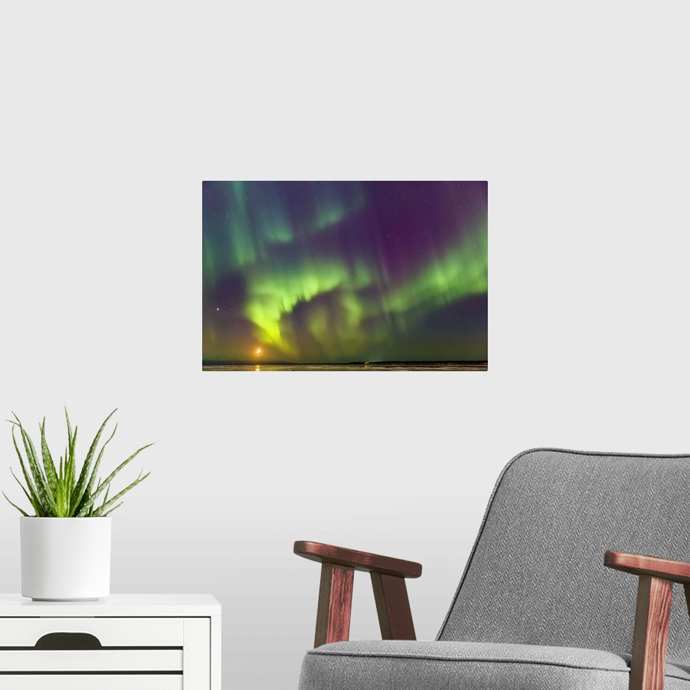 A modern room featuring Northern Lights and moon in the sky above the snow covered mudflats of Knik Arm and Mt. Susitna, ...