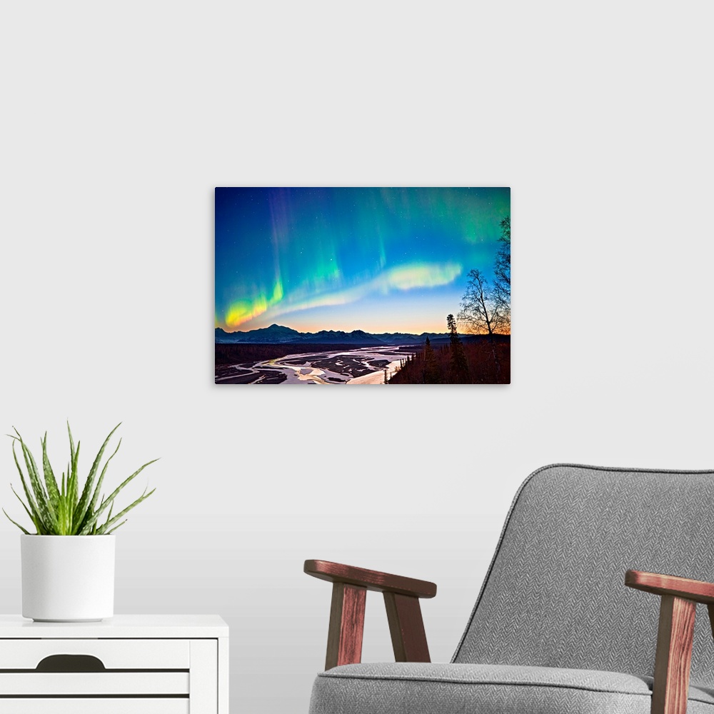 A modern room featuring Northern Lights in the sky above Mount McKinley and the Alaska range at twilight with the glow fr...