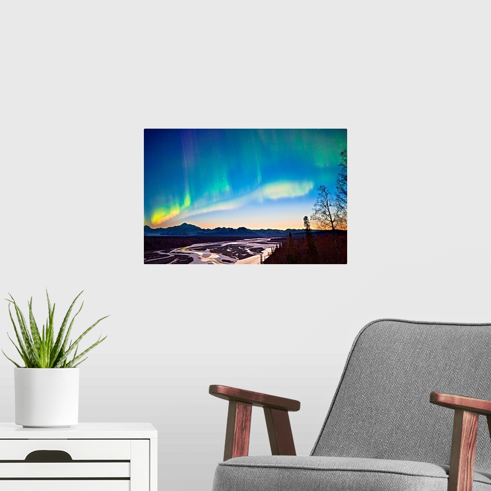 A modern room featuring Northern Lights in the sky above Mount McKinley and the Alaska range at twilight with the glow fr...