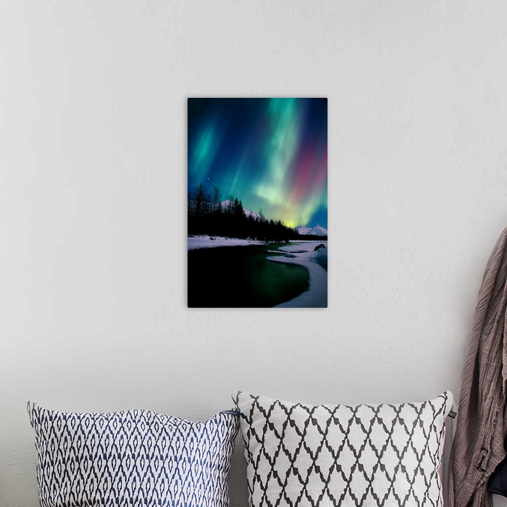 A bohemian room featuring Giant photograph shows the aurora borealis shining in the nighttime sky over a frozen landscape w...