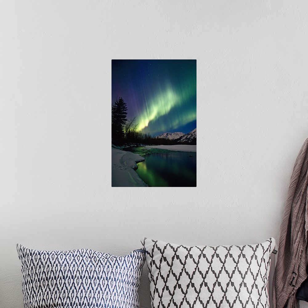 A bohemian room featuring This is a vertical landscape photograph showing the Aurora Borealis reflecting in the still water...
