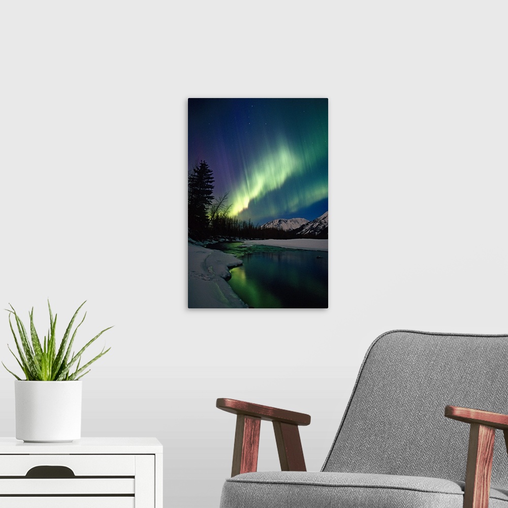 A modern room featuring This is a vertical landscape photograph showing the Aurora Borealis reflecting in the still water...