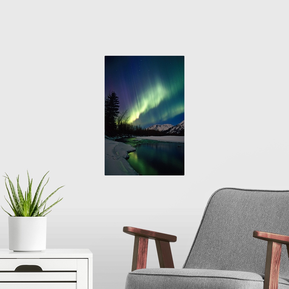 A modern room featuring This is a vertical landscape photograph showing the Aurora Borealis reflecting in the still water...