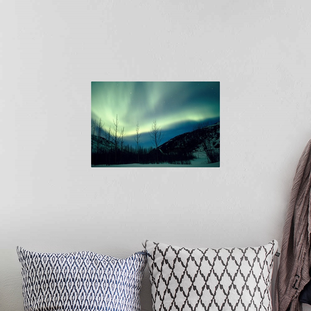 A bohemian room featuring Big horizontal photograph of the northern lights over a snow covered valley in Alaska.