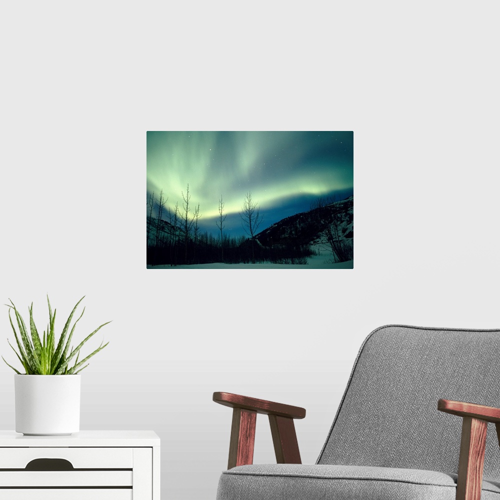 A modern room featuring Big horizontal photograph of the northern lights over a snow covered valley in Alaska.