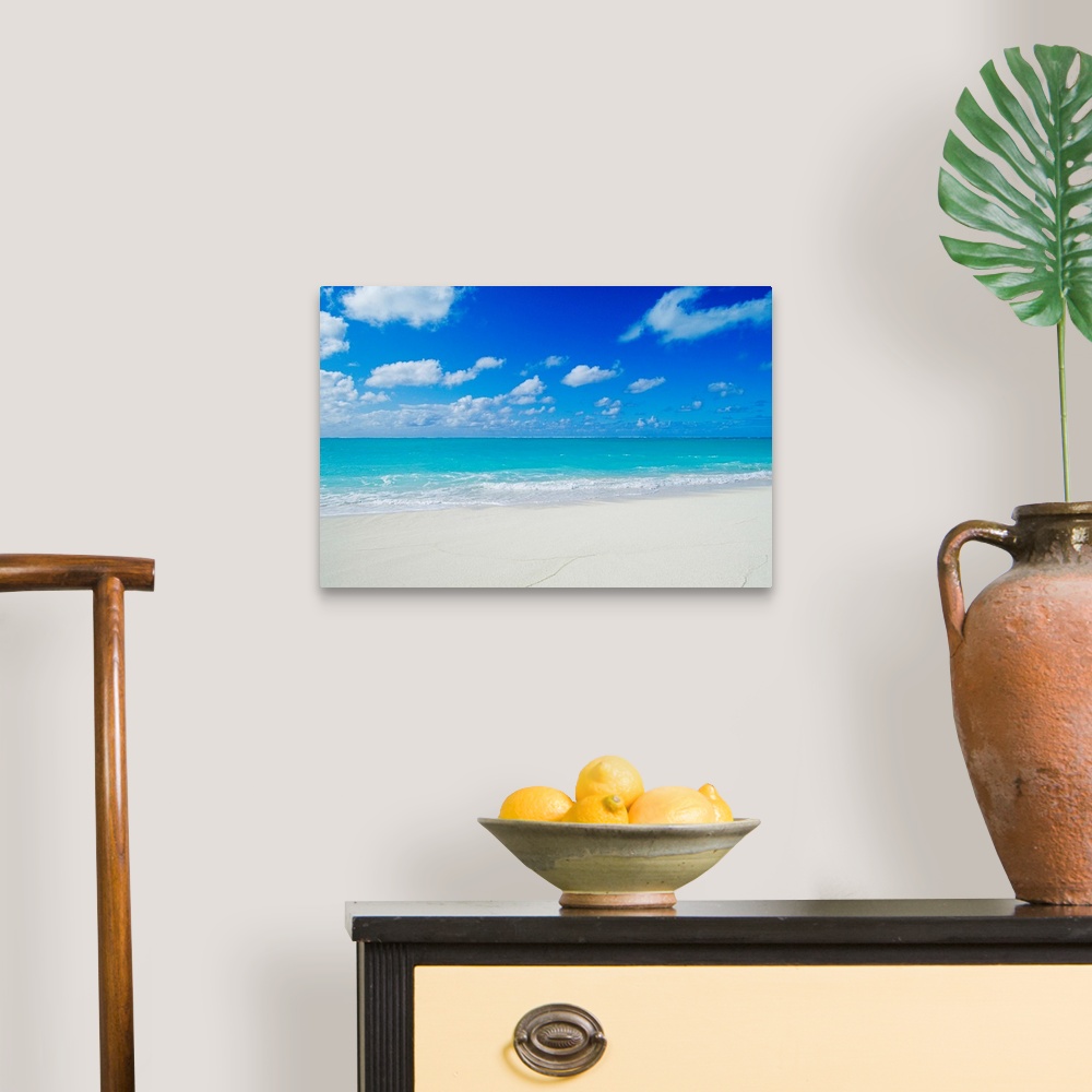 A traditional room featuring Photograph of white sandy beach and crystal clear blue waters on a calm, clear day in Hawaii.