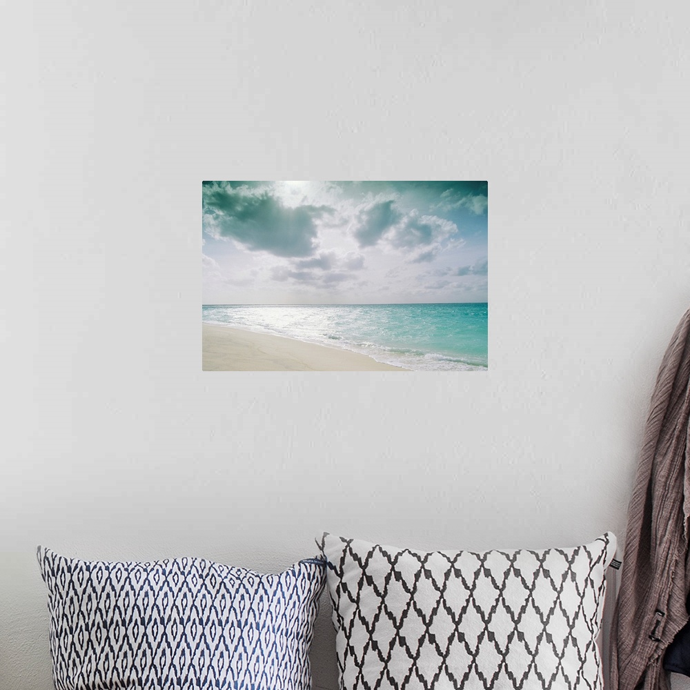 A bohemian room featuring Large, landscape photograph of the shoreline along Sand Island meeting the clear blue waters over...
