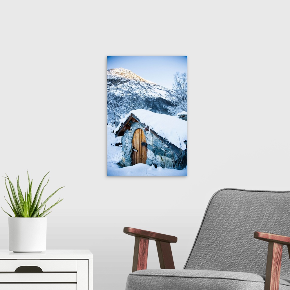 A modern room featuring Norway, Sognefjord, snow covered traditional stone building which houses hydro electric generator...