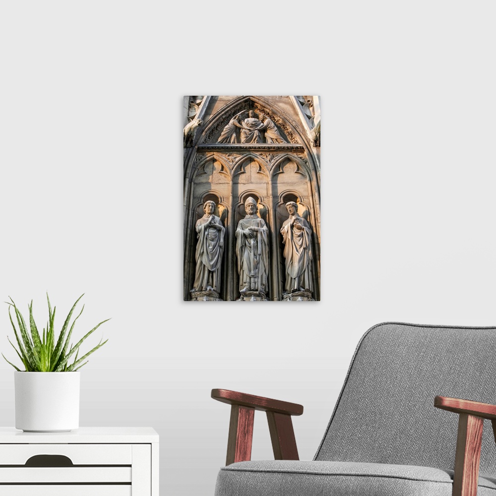 A modern room featuring Notre Dame Cathedral. South facade. Apostle sculptures.