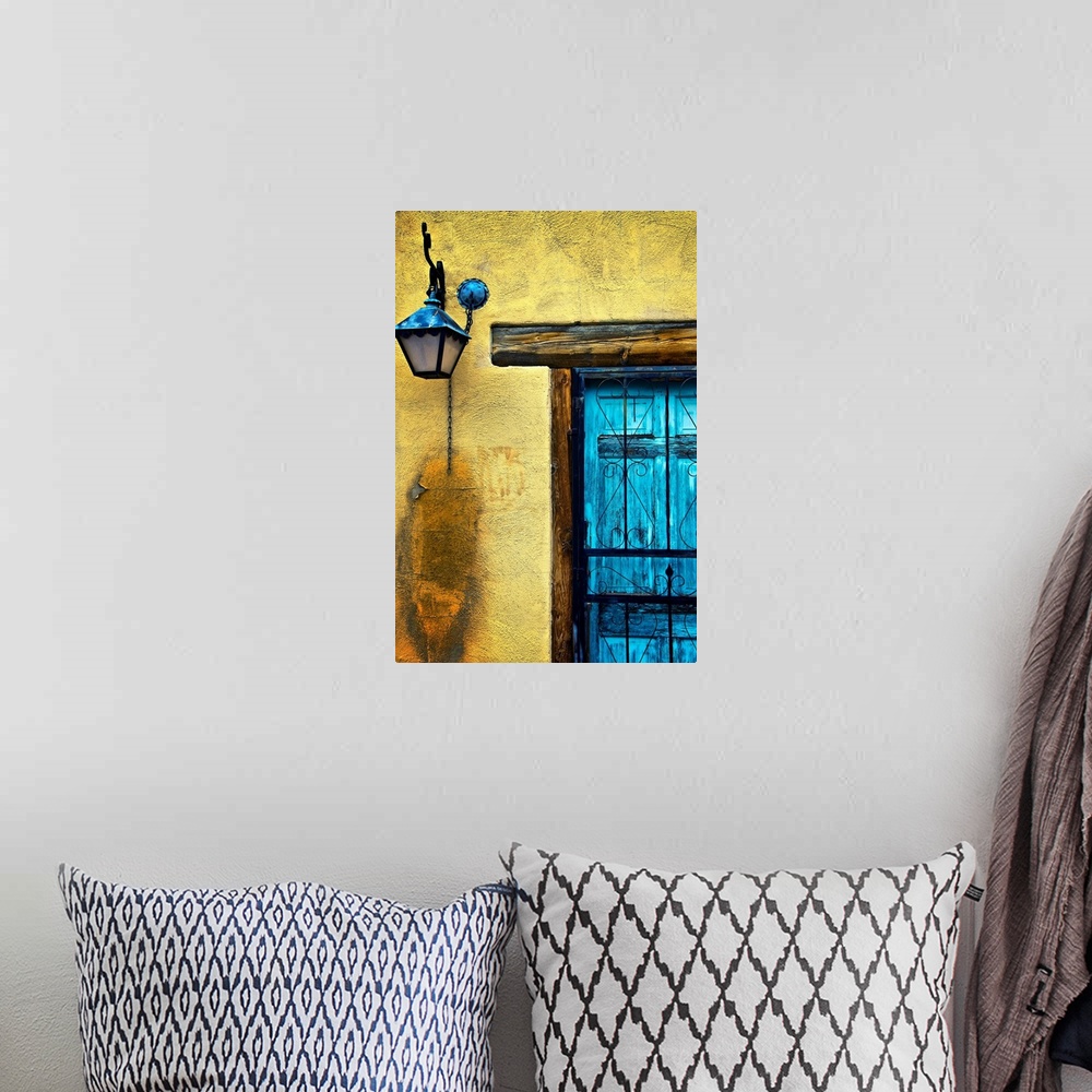 A bohemian room featuring Vertical panoramic photograph of bright colorful door on stone wall.