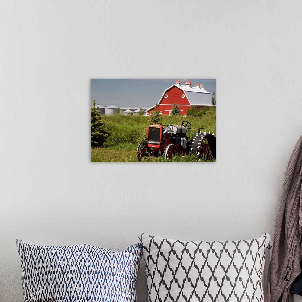 A bohemian room featuring Old Red Tractor In A Field With A Red Barn In The Background, Alberta, Canada