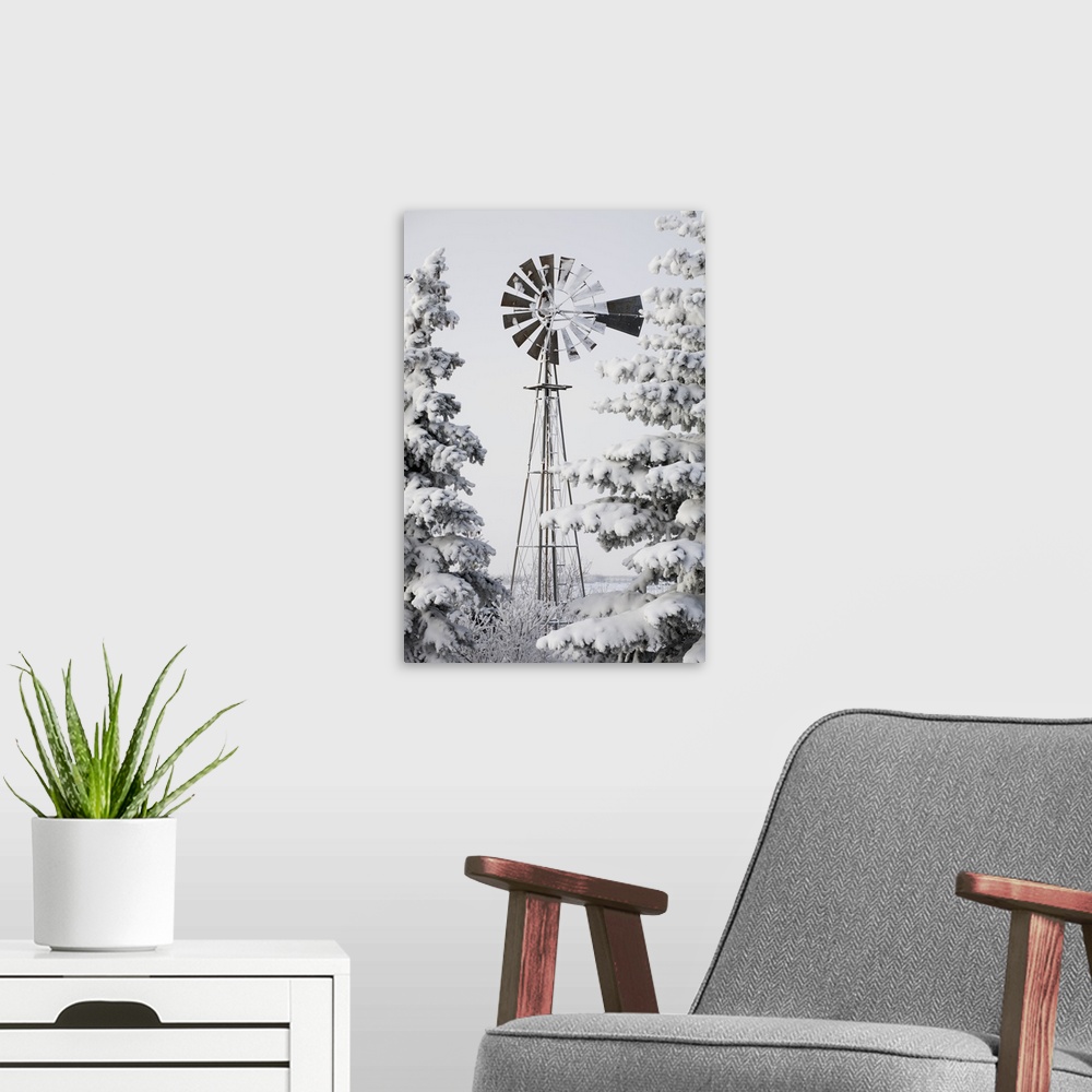 A modern room featuring Old Windmill And Trees Covered With Snow And Frost; Calgary, Alberta, Canada