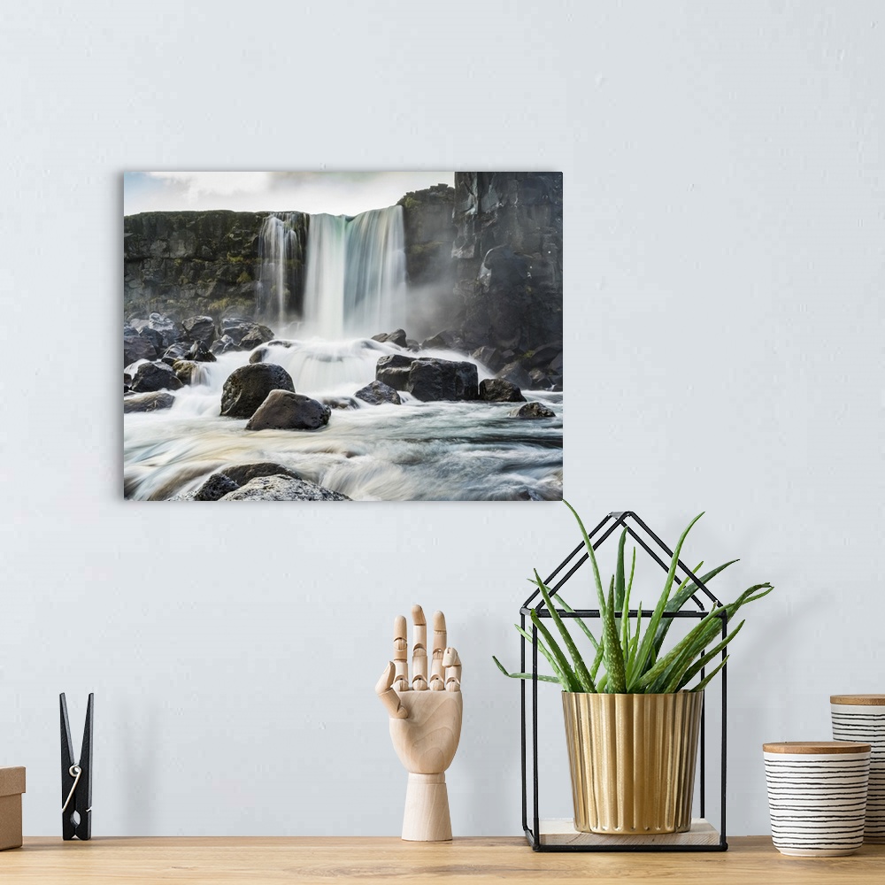 A bohemian room featuring Oxararfoss waterfall in Thingvellir, a historic site and national park.  It's known for the Althi...